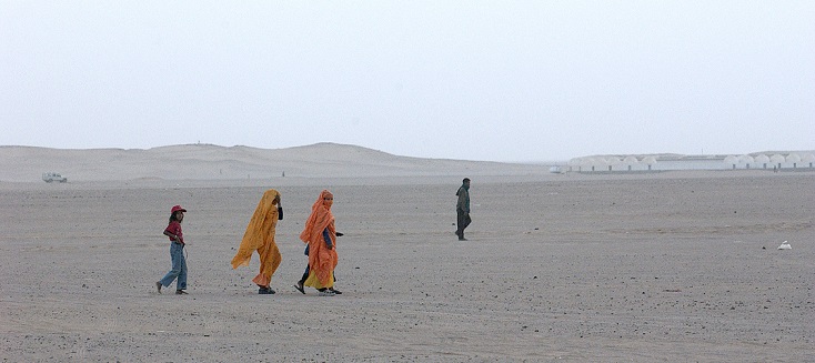 Refugees walk near the Awsard Refugee Camp.