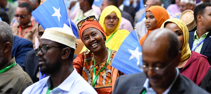 Women laughs at the camera during a meeting of senior officials of the Federal Government of Somalia and Federal Member States, UN representatives and members of civil society organizations at the closing session of the national constitutional convention in Mogadishu on 15 May 2018. 
