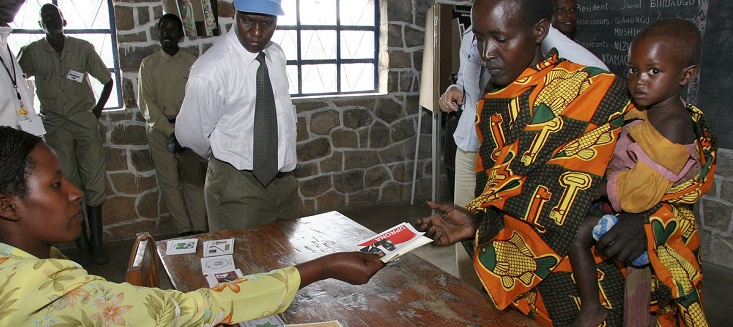 Under the eyes of international observers a woman gets her voter's cards for the election of communal councillors in Cancuzo in Burundi. June 2005 