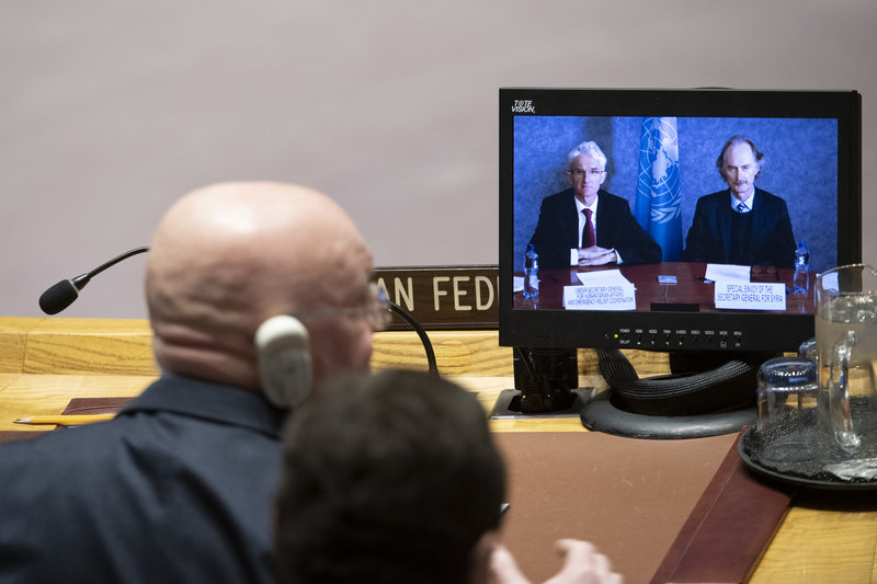 Mark Lowcock (left on screen), Under-Secretary-General for Humanitarian Affairs and Emergency Relief Coordinator, and Geir O. Pederson (right on screen), Special Envoy for Syria, brief the Security Council meeting on the situation in Syria. Listening in the foreground is Vassily Nebenzia, Permanent Representative of the Russian Federation to the United Nations.